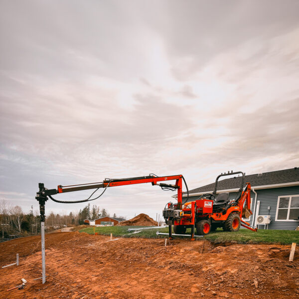 Boom with a 9 to 14 ft reach and a 270° rotating drive head installing a screw pile perfectly straight